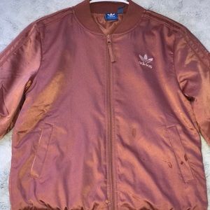 A light pink adidas (winder-breaker) type jacket
